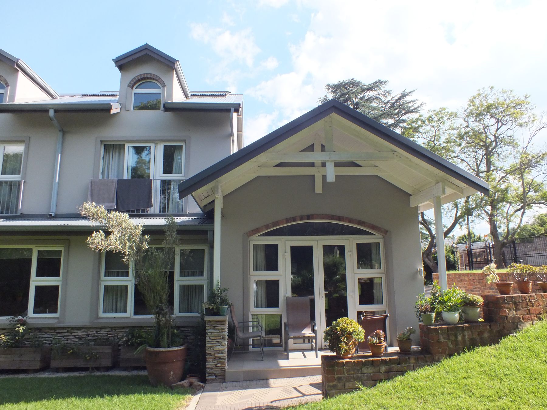 Atholl house with a new gabled garden room and terraced stone planters