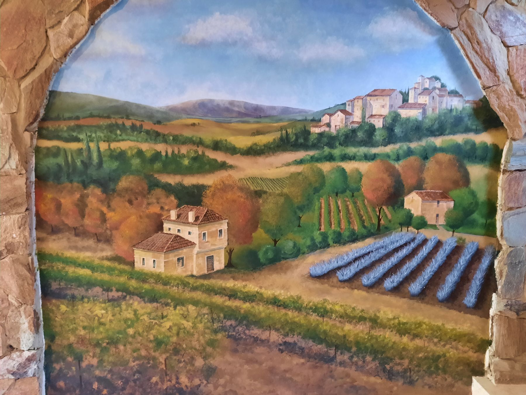 Detail of a hand-painted Tuscan landscape mural in Bryanston by Debby Searle