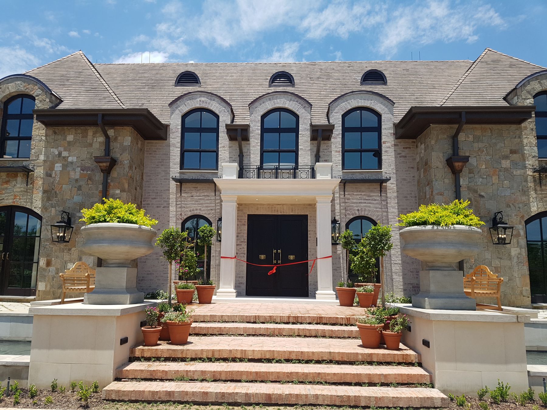 Symmetrical stone manor house at Steyn City with arched dormers and a columned entrance