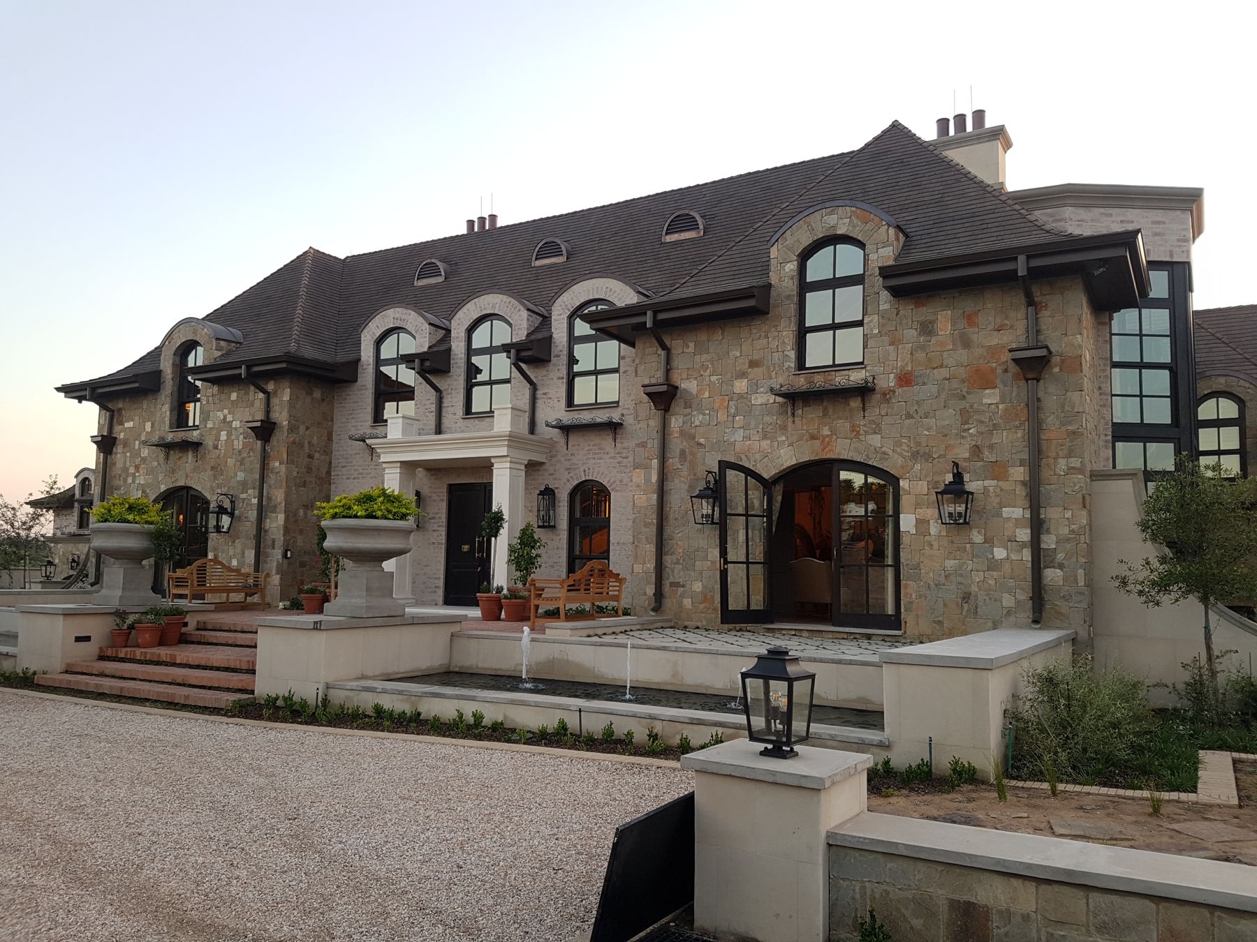 The entrance front at dusk — New house in Steyn City