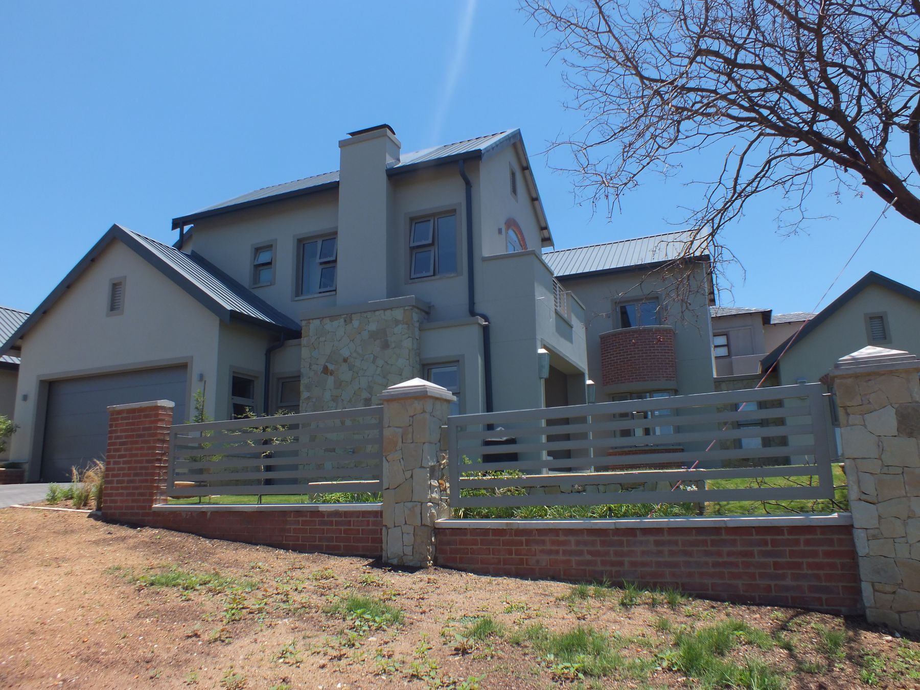 New gabled house at Waterfall Country Estate with a stone chimney